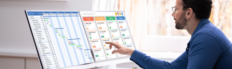 A man looking over an effective content calendar on two screen monitors.