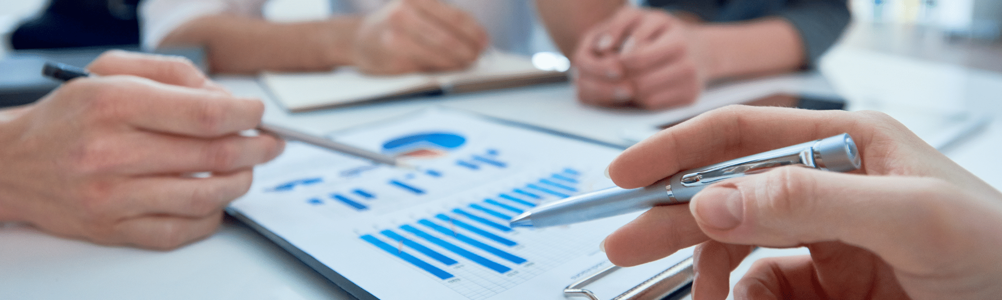 A team looking over graphs trying to determine an effective strategy for local marketing.