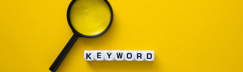 Yellow background featuring the word "keyword” for a fencing contractor PPC campaign with a magnifying glass overlay.