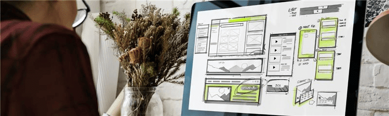 A woman looks at a screen showing a design integrating SEO and content.
